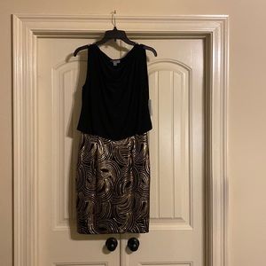 Sleeveless dress, black blowsy top over golden copper sequined bottom